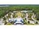 Aerial view of community featuring clubhouse, pool, playground, and green space at 17628 Breakaway St, Land O Lakes, FL 34638