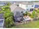 Aerial view of backyard featuring a screened-in lanai, lounge area, and well-maintained lawn at 17628 Breakaway St, Land O Lakes, FL 34638