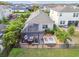 Aerial view of backyard featuring a screened-in lanai, lounge area, and well-maintained lawn at 17628 Breakaway St, Land O Lakes, FL 34638