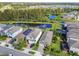 Aerial view showcasing homes with solar panels, ponds, and well-manicured lawns at 17628 Breakaway St, Land O Lakes, FL 34638