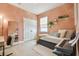 This bedroom is decorated with salmon colored walls and white trim at 17628 Breakaway St, Land O Lakes, FL 34638