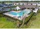 Aerial of the community pool with plenty of seating, palm trees, and lush landscaping at 17628 Breakaway St, Land O Lakes, FL 34638