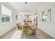 View of a dining room leading into a modern kitchen, both well lit with natural light at 17628 Breakaway St, Land O Lakes, FL 34638