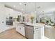 Bright, modern kitchen with a stainless steel farmhouse sink, quartz countertops, and open layout with seamless flow to living spaces at 17628 Breakaway St, Land O Lakes, FL 34638