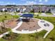 Community playground featuring swings and a covered play structure with picnic tables at 17628 Breakaway St, Land O Lakes, FL 34638