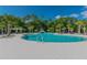 The community pool offers clear blue water, a splash pad, and lounge seating at 17628 Breakaway St, Land O Lakes, FL 34638