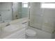 White bathroom featuring tiled shower/tub, sink, and mirror at 1814 Wood Trail St, Tarpon Springs, FL 34689