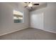 Neutral bedroom offers a ceiling fan, window and closet with double doors at 1814 Wood Trail St, Tarpon Springs, FL 34689