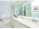 Elegant bathroom with double sinks, bathtub, and a large mirror at 18934 Avenue Biarritz, Lutz, FL 33558