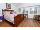 Cozy bedroom with wooden furniture and a large window, flooding the room with natural light at 18934 Avenue Biarritz, Lutz, FL 33558