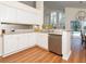 Well-lit kitchen with stainless steel appliances, white cabinetry, and a breakfast bar at 18934 Avenue Biarritz, Lutz, FL 33558