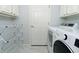 A functional laundry room equipped with modern appliances and ample storage at 18934 Avenue Biarritz, Lutz, FL 33558