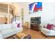 Bright living room featuring hardwood floors, a staircase, and colorful artwork at 18934 Avenue Biarritz, Lutz, FL 33558