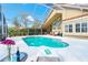 Sparkling pool in a screened enclosure with patio seating and a view of the home's exterior at 18934 Avenue Biarritz, Lutz, FL 33558