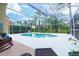 Enclosed pool area with clear blue water, lounge chairs, and lush tropical landscaping at 18934 Avenue Biarritz, Lutz, FL 33558