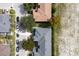 Overhead shot showcases rooflines, leafy trees, and parked cars in residential area at 2032 Sunset Meadow Dr, Clearwater, FL 33763