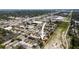 An aerial view of a townhouse complex near commercial districts, surrounded by greenery and highways at 2032 Sunset Meadow Dr, Clearwater, FL 33763