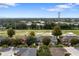 An aerial view of townhouses surrounded by lush greenery, with a glimpse of the cityscape at 2032 Sunset Meadow Dr, Clearwater, FL 33763