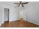 Bedroom featuring wood-look floors, ceiling fan, and closet at 2032 Sunset Meadow Dr, Clearwater, FL 33763