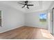 A spacious bedroom with tray ceiling, ceiling fan, and a bright neutral color scheme at 2032 Sunset Meadow Dr, Clearwater, FL 33763