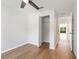 Bright bedroom featuring wood-look floors, ceiling fan, and an open closet at 2032 Sunset Meadow Dr, Clearwater, FL 33763