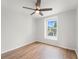 Bedroom with wood-look floors and a window view at 2032 Sunset Meadow Dr, Clearwater, FL 33763