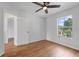 Bedroom featuring wood-look floors and a window view at 2032 Sunset Meadow Dr, Clearwater, FL 33763