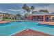 Resort-style community pool with ample seating, a covered lounge area, and well-maintained landscaping at 2032 Sunset Meadow Dr, Clearwater, FL 33763