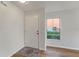 Inviting entryway with a white front door, neutral walls, a decorative rug, and a window providing natural light at 2032 Sunset Meadow Dr, Clearwater, FL 33763