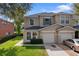 Charming two-story townhouse with manicured lawn and attached one-car garage at 2032 Sunset Meadow Dr, Clearwater, FL 33763