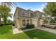 Charming two-story townhome featuring a well-manicured lawn and attached garage at 2032 Sunset Meadow Dr, Clearwater, FL 33763