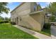 Exterior view of home showcasing lush green lawn, manicured shrubbery, and a well-maintained sidewalk at 2032 Sunset Meadow Dr, Clearwater, FL 33763