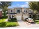 Charming two-story townhouse with attached garages, a well-kept lawn, and a neatly paved driveway at 2032 Sunset Meadow Dr, Clearwater, FL 33763