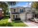 Charming two-story townhouse with manicured lawn and attached one-car garage at 2032 Sunset Meadow Dr, Clearwater, FL 33763