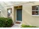 Inviting front entrance with 'Home Sweet Home' doormat, flanked by manicured greenery and natural light at 2032 Sunset Meadow Dr, Clearwater, FL 33763