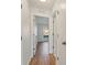 Hallway with wood floors, white walls, white trim, and doors leading to other rooms at 2032 Sunset Meadow Dr, Clearwater, FL 33763