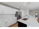 Stylish kitchen featuring white cabinets, quartz countertops, and stainless steel appliances at 2032 Sunset Meadow Dr, Clearwater, FL 33763