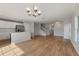 Open concept living room with hardwood floors, a chandelier, a modern kitchen, and staircase at 2032 Sunset Meadow Dr, Clearwater, FL 33763