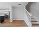 View of the staircase with white banister and wood steps, connecting to the kitchen and upper levels at 2032 Sunset Meadow Dr, Clearwater, FL 33763