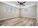 Bright bedroom with new laminate flooring, ceiling fan and natural light at 2043 Erin Dr, Holiday, FL 34690