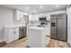 Contemporary kitchen with stainless steel appliances, white cabinetry, and bright countertops at 2043 Erin Dr, Holiday, FL 34690