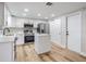 Modern kitchen featuring stainless steel appliances, white cabinetry, and a functional island at 2043 Erin Dr, Holiday, FL 34690