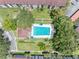 Aerial shot of the community pool surrounded by trees and well-maintained lawns at 2583 Countryside Blvd # 3212, Clearwater, FL 33761