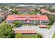 Aerial view of a condominium complex with a red roof and ample parking at 2583 Countryside Blvd # 3212, Clearwater, FL 33761