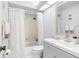 Bathroom with shower-tub combo, white tile, and ample lighting at 2583 Countryside Blvd # 3212, Clearwater, FL 33761