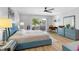 Spacious bedroom with light blue furniture and private balcony access at 2583 Countryside Blvd # 3212, Clearwater, FL 33761