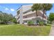 Exterior view of the building showing balconies and the property's well-maintained landscaping at 2583 Countryside Blvd # 3212, Clearwater, FL 33761