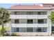 Exterior of a condo building with multiple balconies and lush landscaping at 2583 Countryside Blvd # 3212, Clearwater, FL 33761