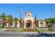 Elegant clubhouse entrance featuring manicured landscaping, palm trees, and classic architectural details at 2717 Via Cipriani # 623B, Clearwater, FL 33764