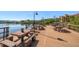 Community dock on the water features wooden picnic tables and benches for relaxing at 2717 Via Cipriani # 623B, Clearwater, FL 33764